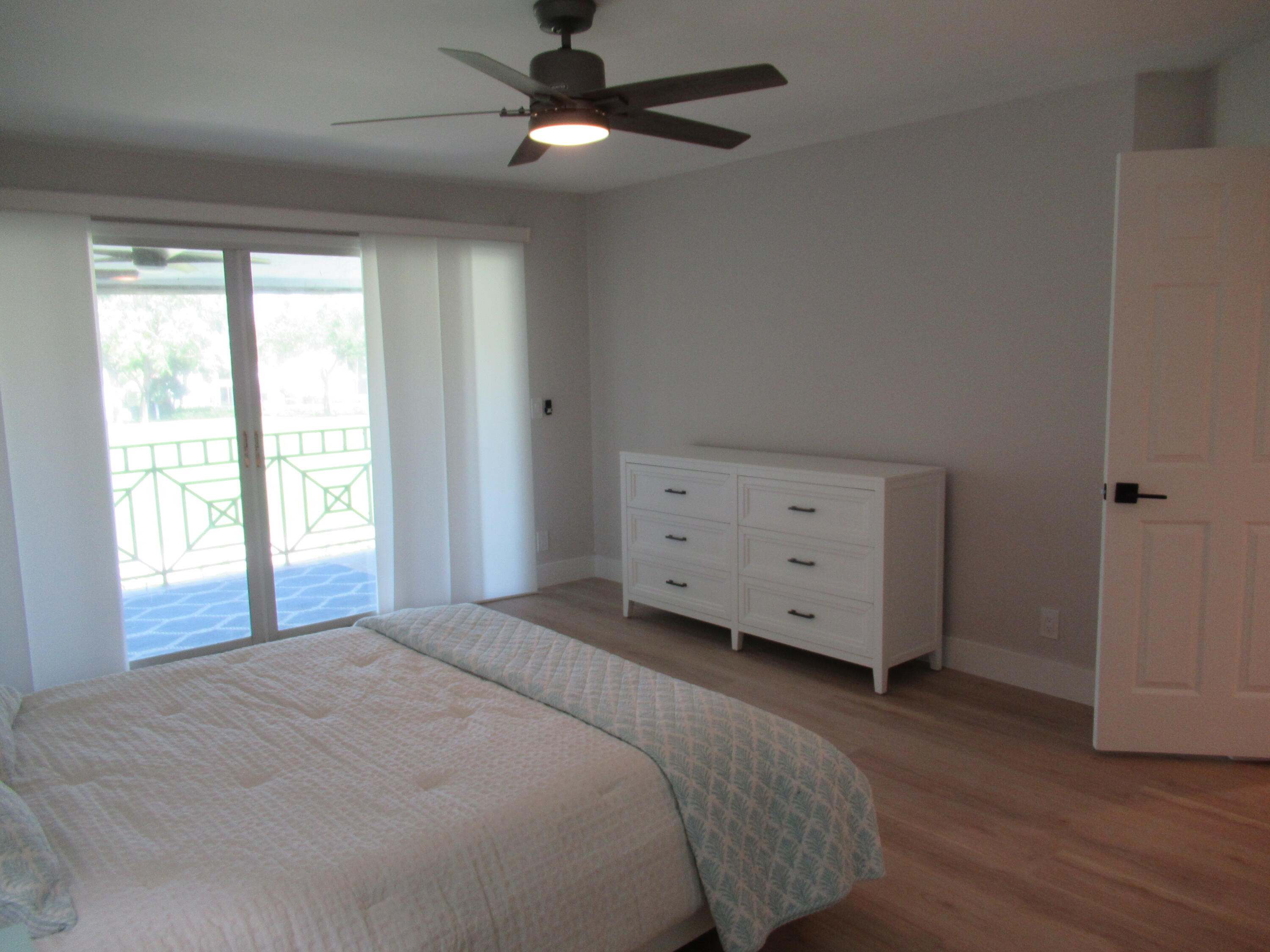 2237 Northwest 53rd Street Boca Raton, FL 33496 - Photo 38 of 76 a spacious bedroom with a bed and a window