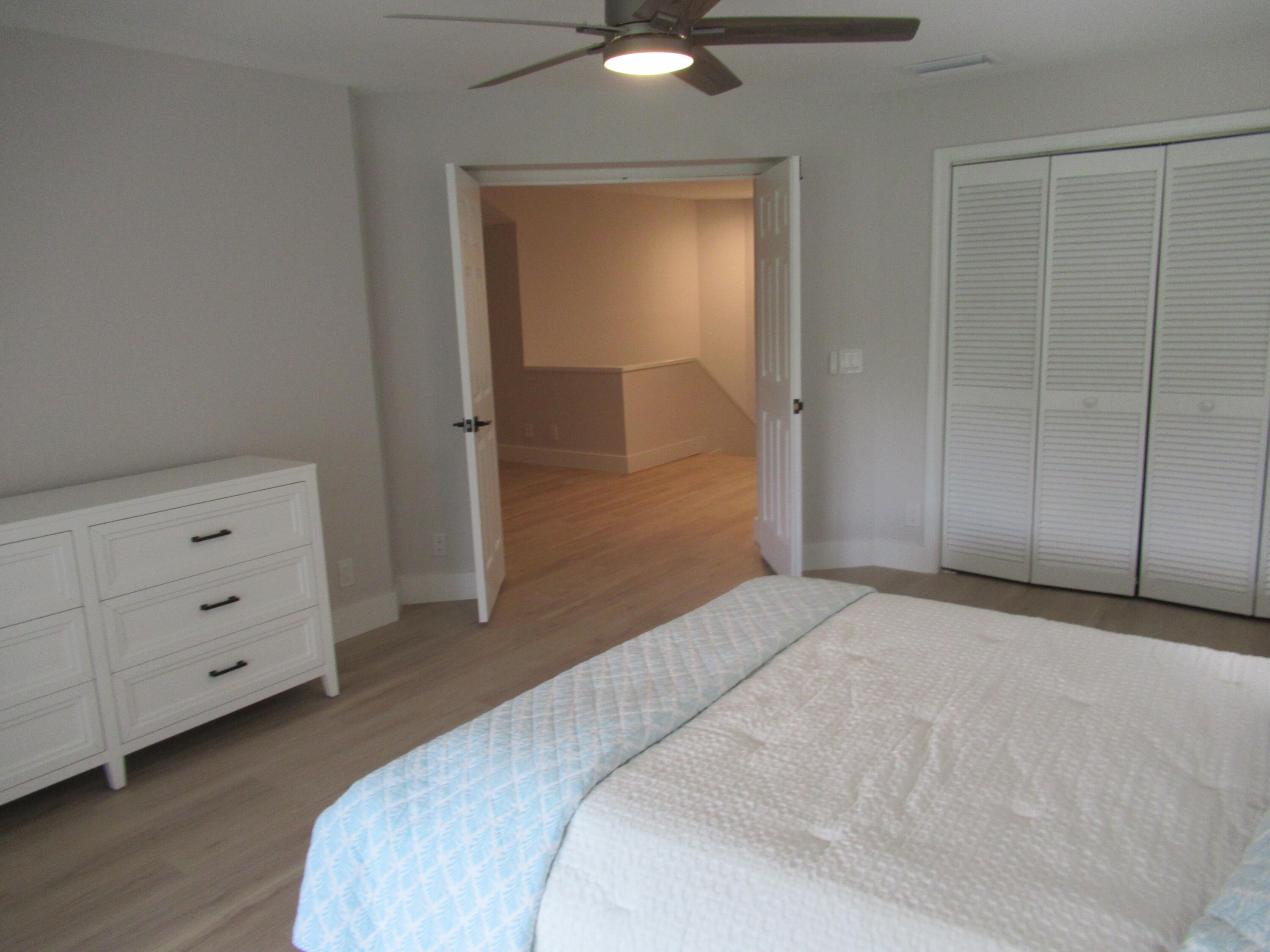 2237 Northwest 53rd Street Boca Raton, FL 33496 - Photo 41 of 76 a bedroom with a bed and a dresser