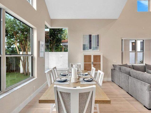 2237 Northwest 53rd Street Boca Raton, FL 33496 - Photo 7 of 76 a living room with furniture a large window and floor to ceiling windows