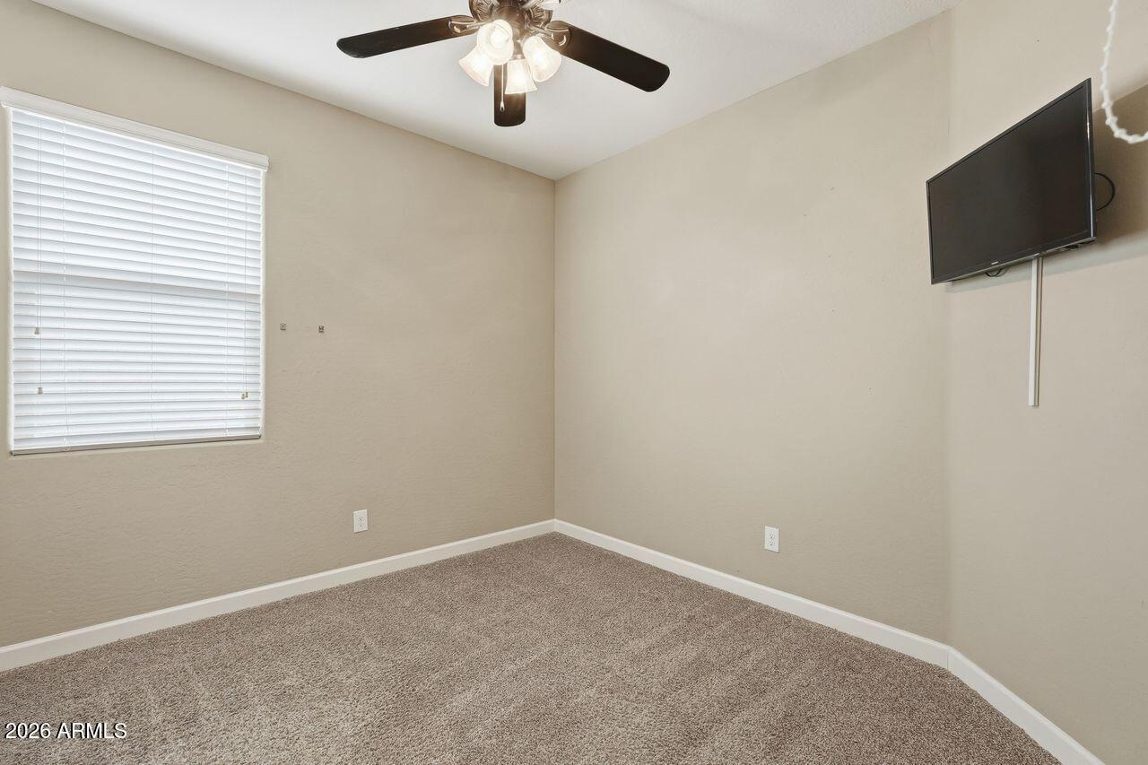 23602 West Ripple Road Buckeye, AZ 85326 - Photo 30 of 38 en empty room with windows and ceiling fan