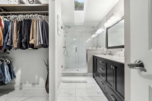 a bathroom with a shower sink and mirror