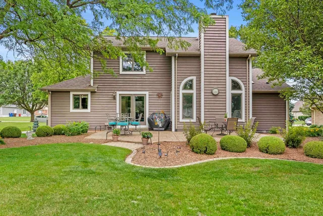 a front view of house with a garden and patio