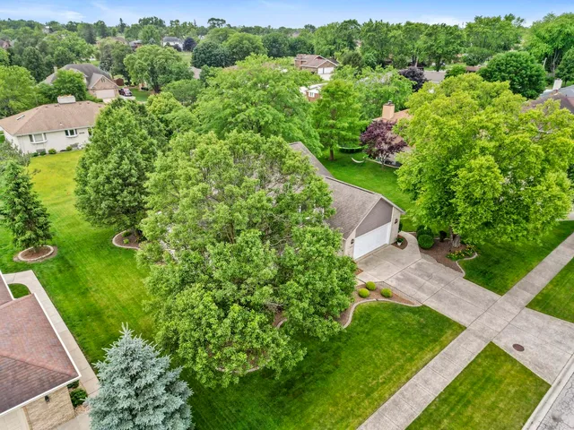 an aerial view of a house with a yard