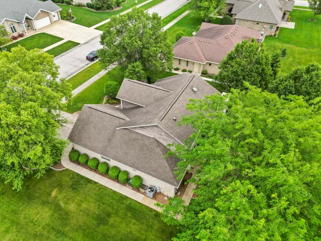 an aerial view of a house with a yard