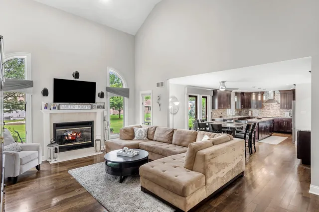 a living room with furniture a fireplace and a flat screen tv