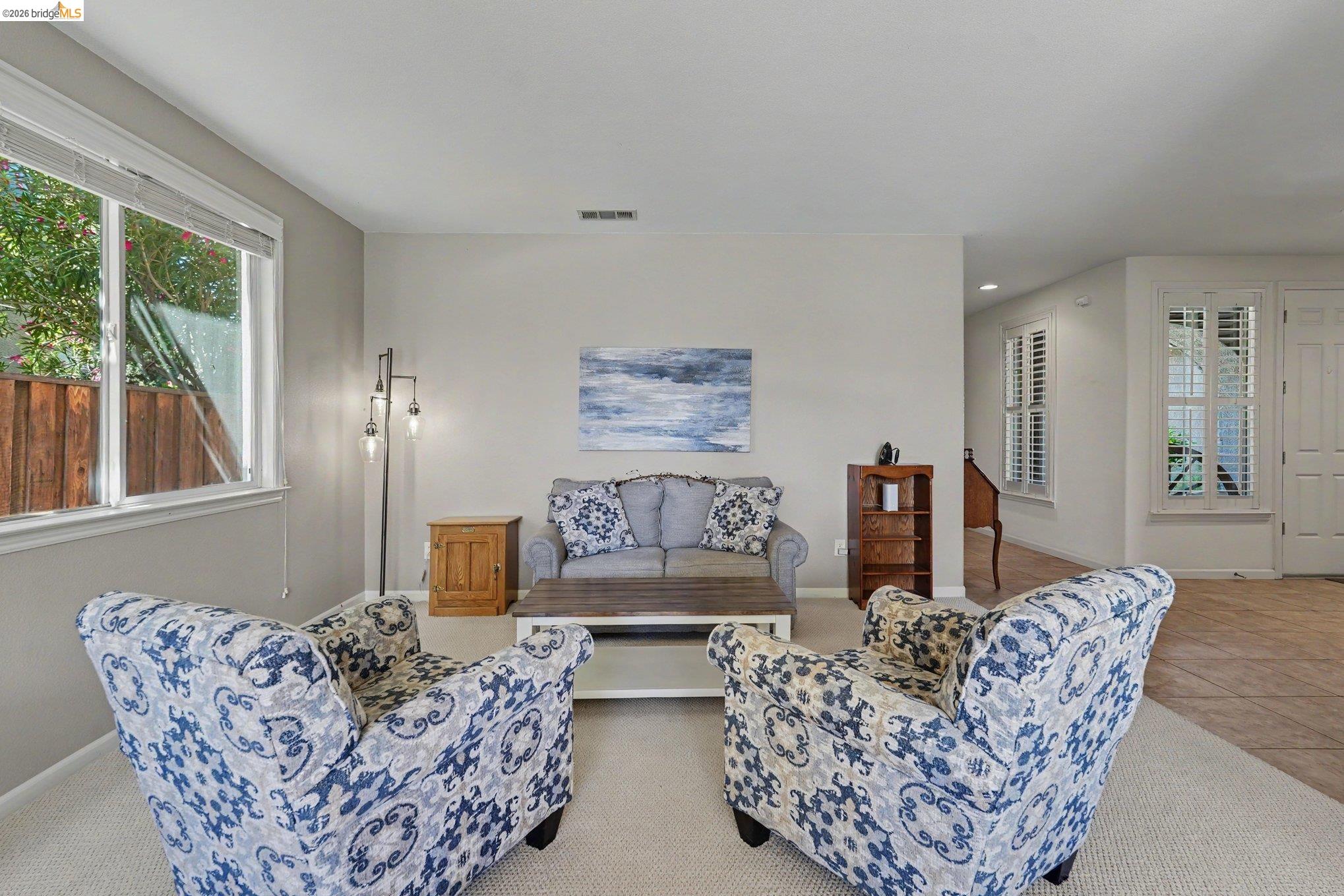 106 Little Ranch Circle Oakley, CA 94561 - Photo 5 of 34 Bright living area featuring neutral wall tones, large windows with white trim, and light-colored carpeting