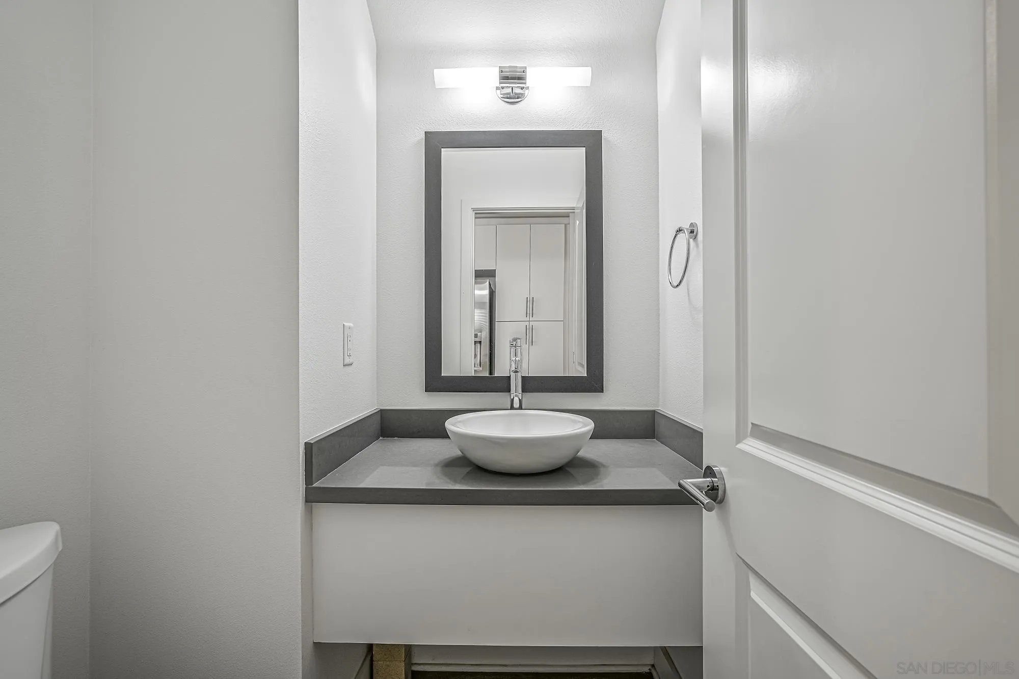 145 Stonesteps Way Encinitas, CA 92024 - Photo 6 of 25 a bathroom with a granite countertop sink and a mirror