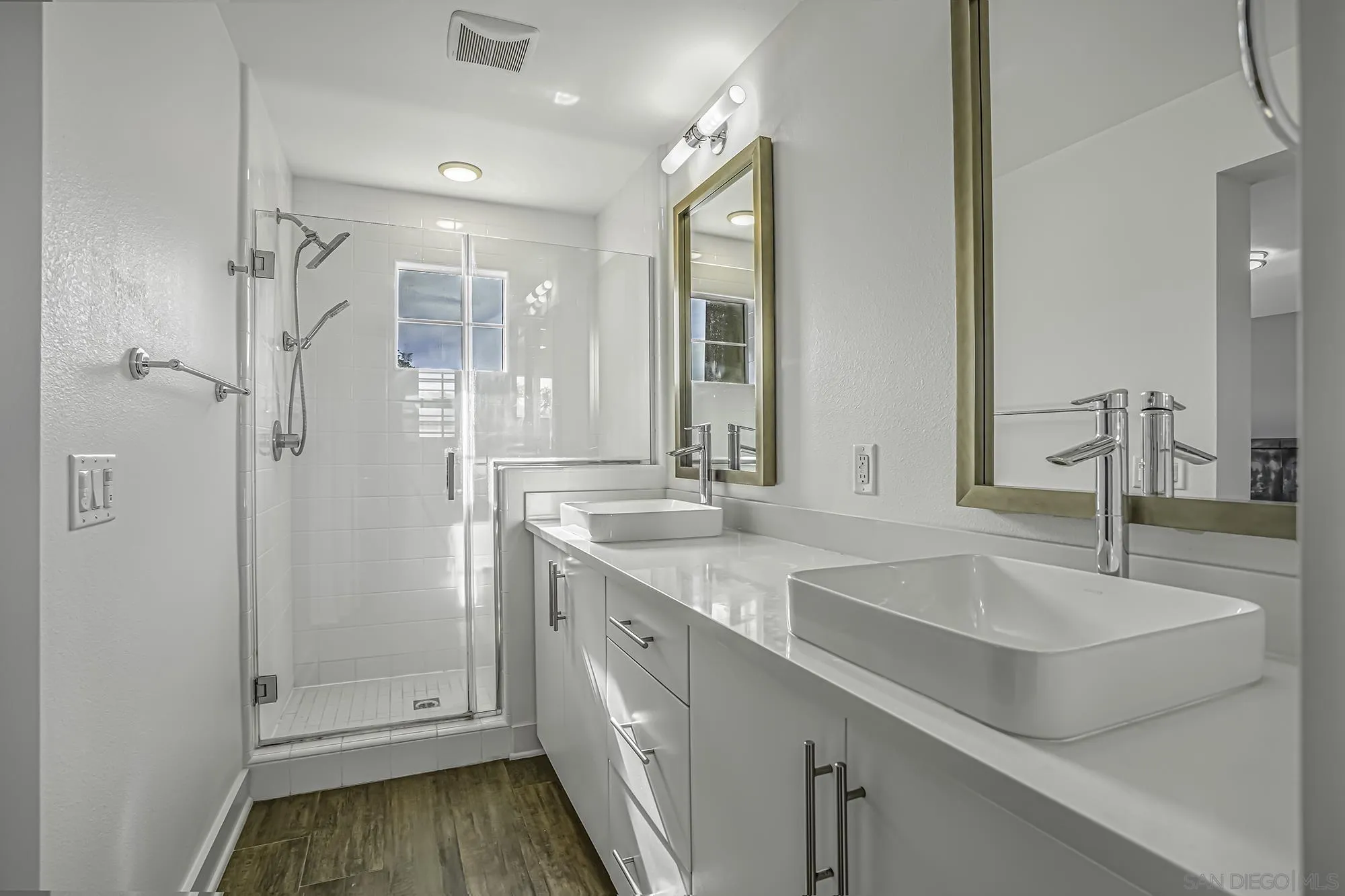 145 Stonesteps Way Encinitas, CA 92024 - Photo 9 of 25 a bathroom with a shower sink vanity and mirror