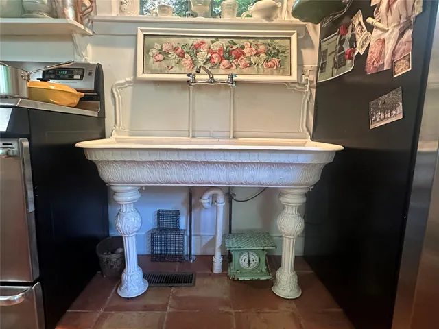 a bathroom with a sink and mirror with bathtub