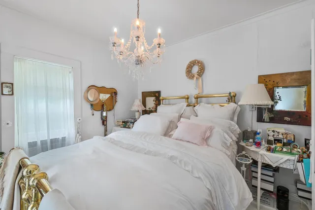 a front view of a house with a yard and tree