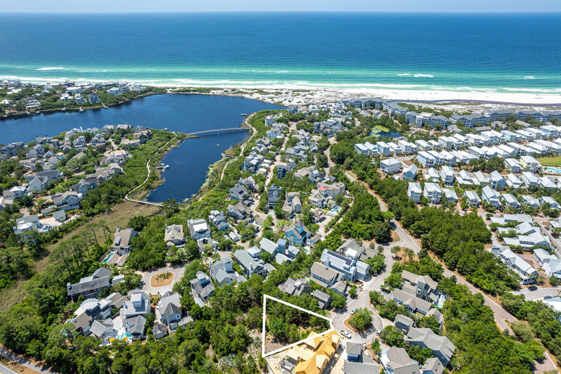 an aerial view of a houses with ocean view