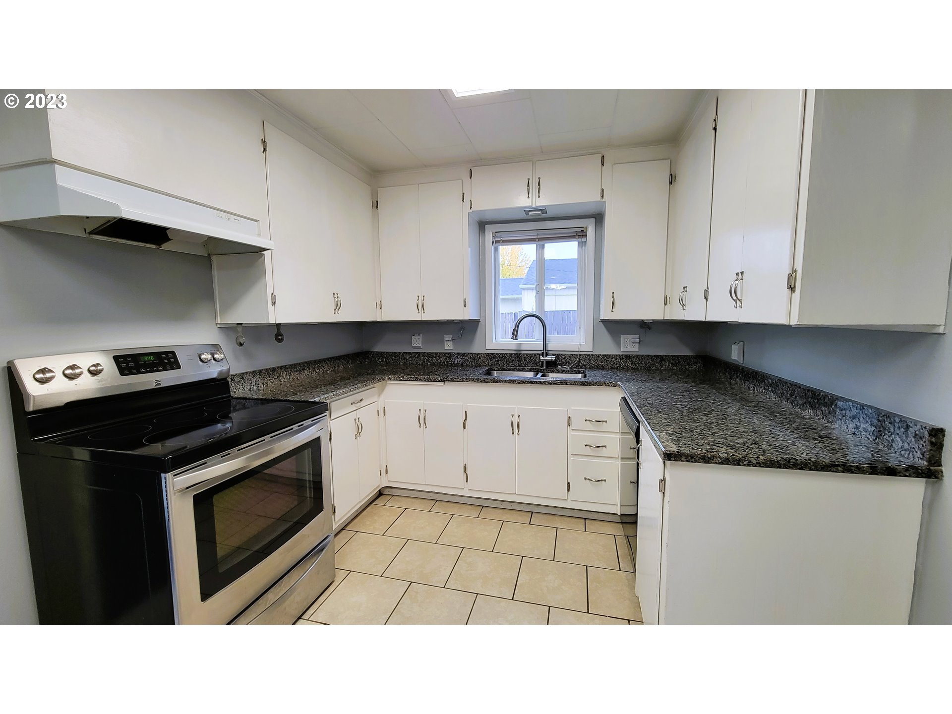 582 36th Street Springfield, OR 97478 - Photo 7 of 16 a kitchen with granite countertop a stove sink and cabinets
