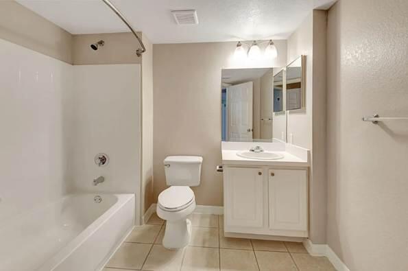 15155 Michelangelo Boulevard, Unit 306 Delray Beach, FL 33446 - Photo 16 of 32 a bathroom with a bathtub shower sink mirror vanity and toilet