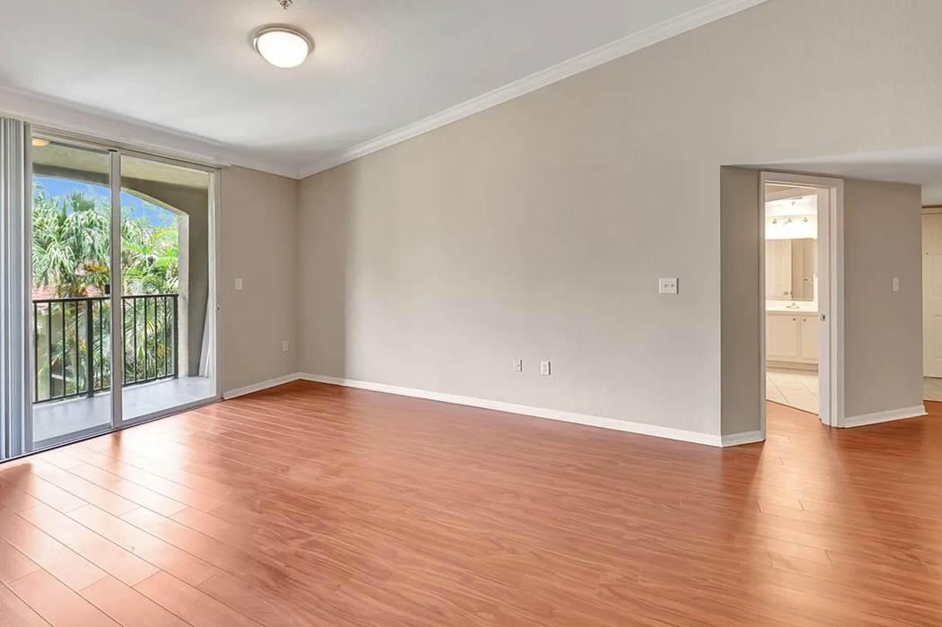 15155 Michelangelo Boulevard, Unit 306 Delray Beach, FL 33446 - Photo 20 of 32 a view of an empty room with wooden floor and a window