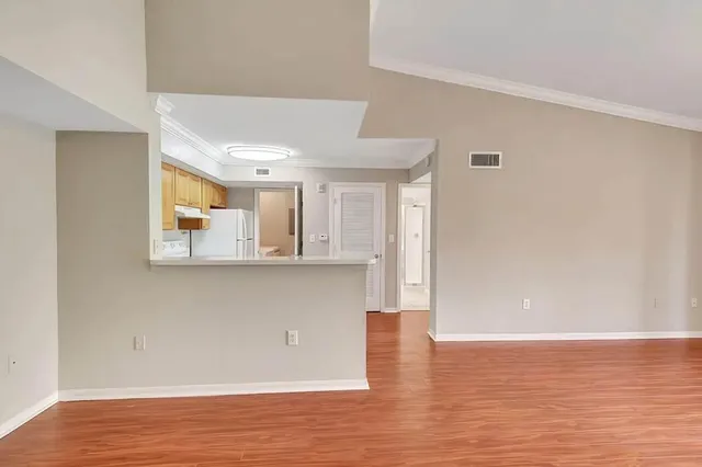 a view of a kitchen with wooden floor and a kitchen