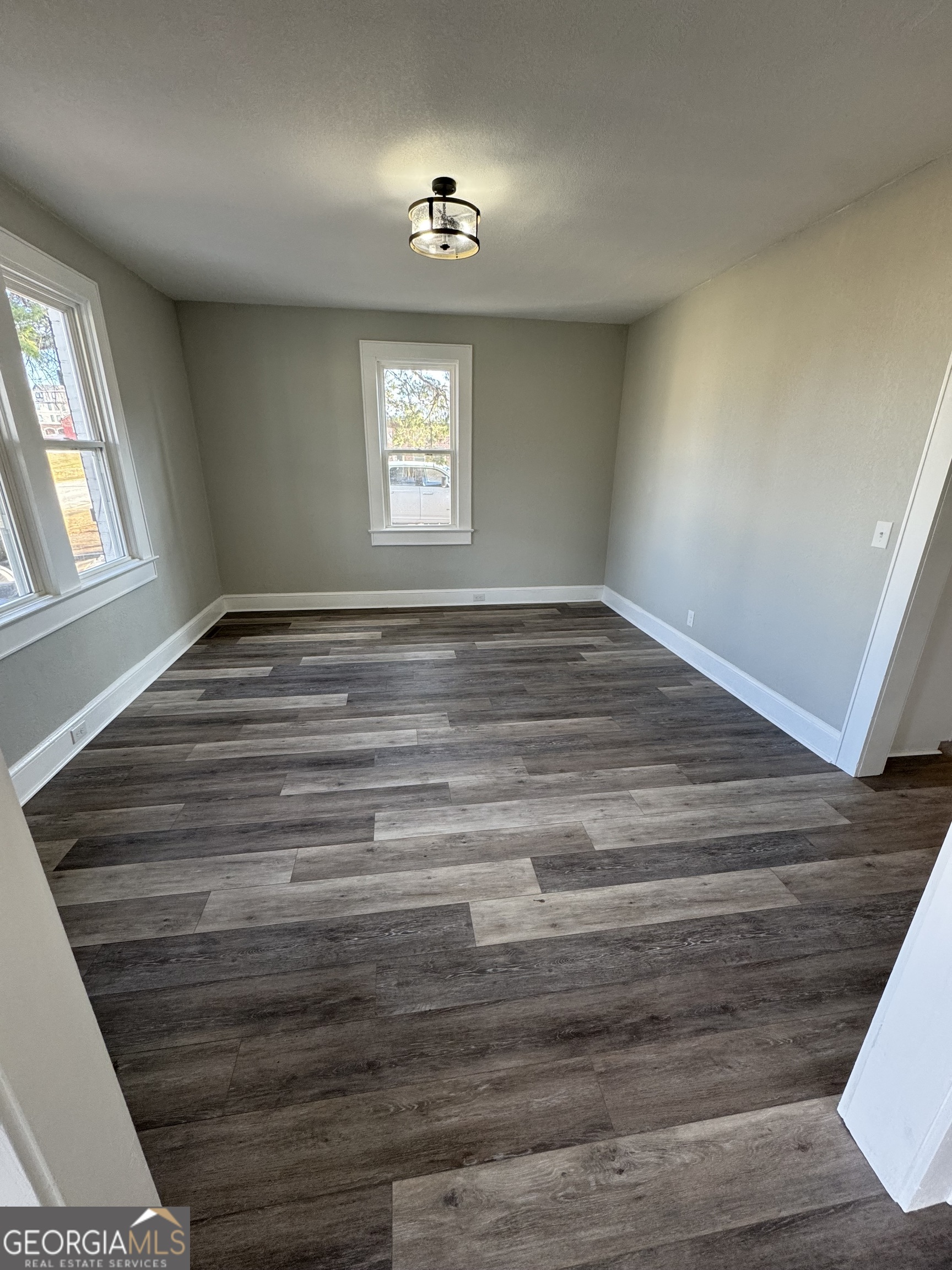 37 West Church Street Elberton, GA 30635 - Photo 11 of 37 a view of empty room with window and wooden floor