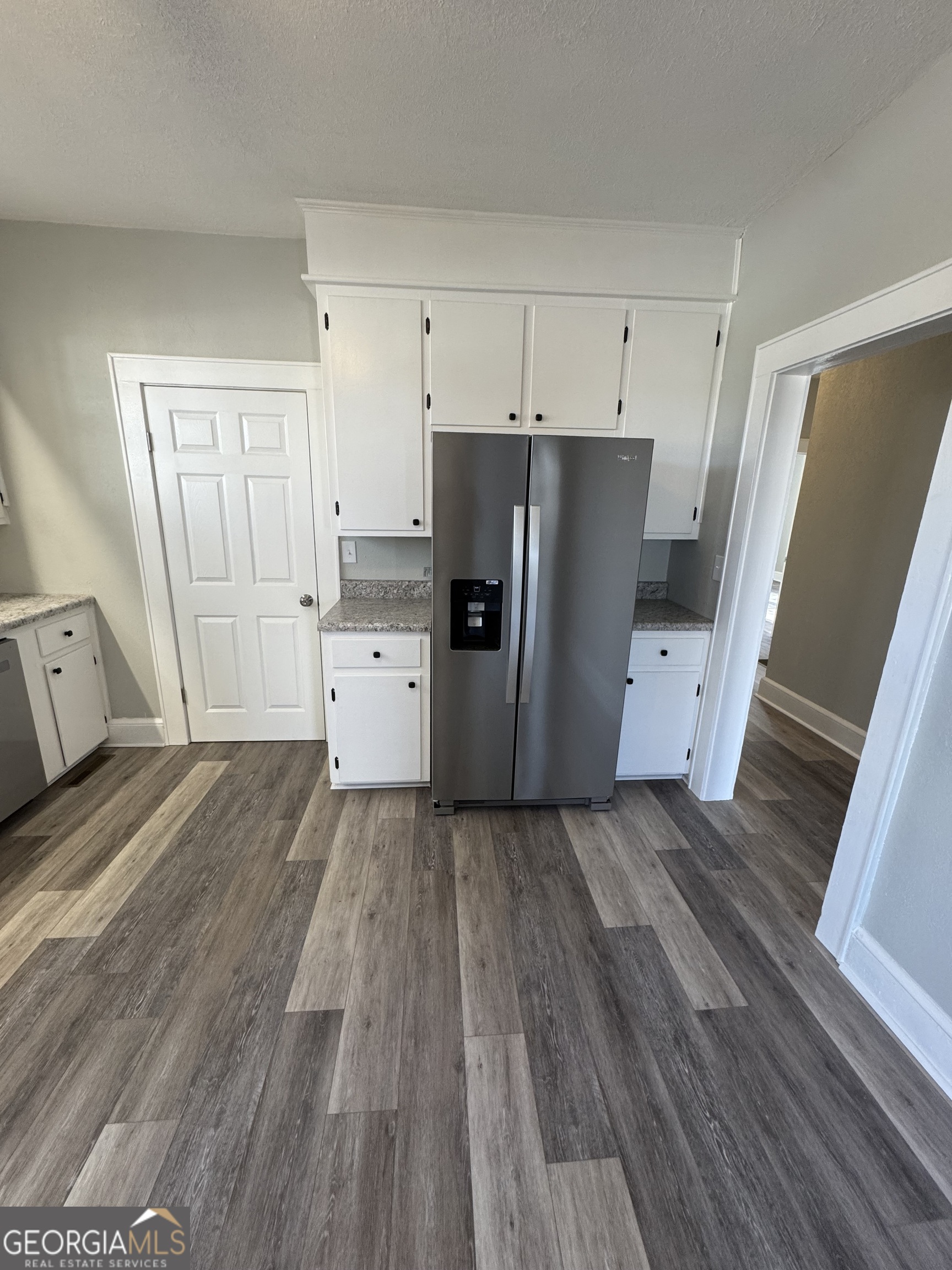 37 West Church Street Elberton, GA 30635 - Photo 12 of 37 a view of a kitchen with refrigerator and wooden floor