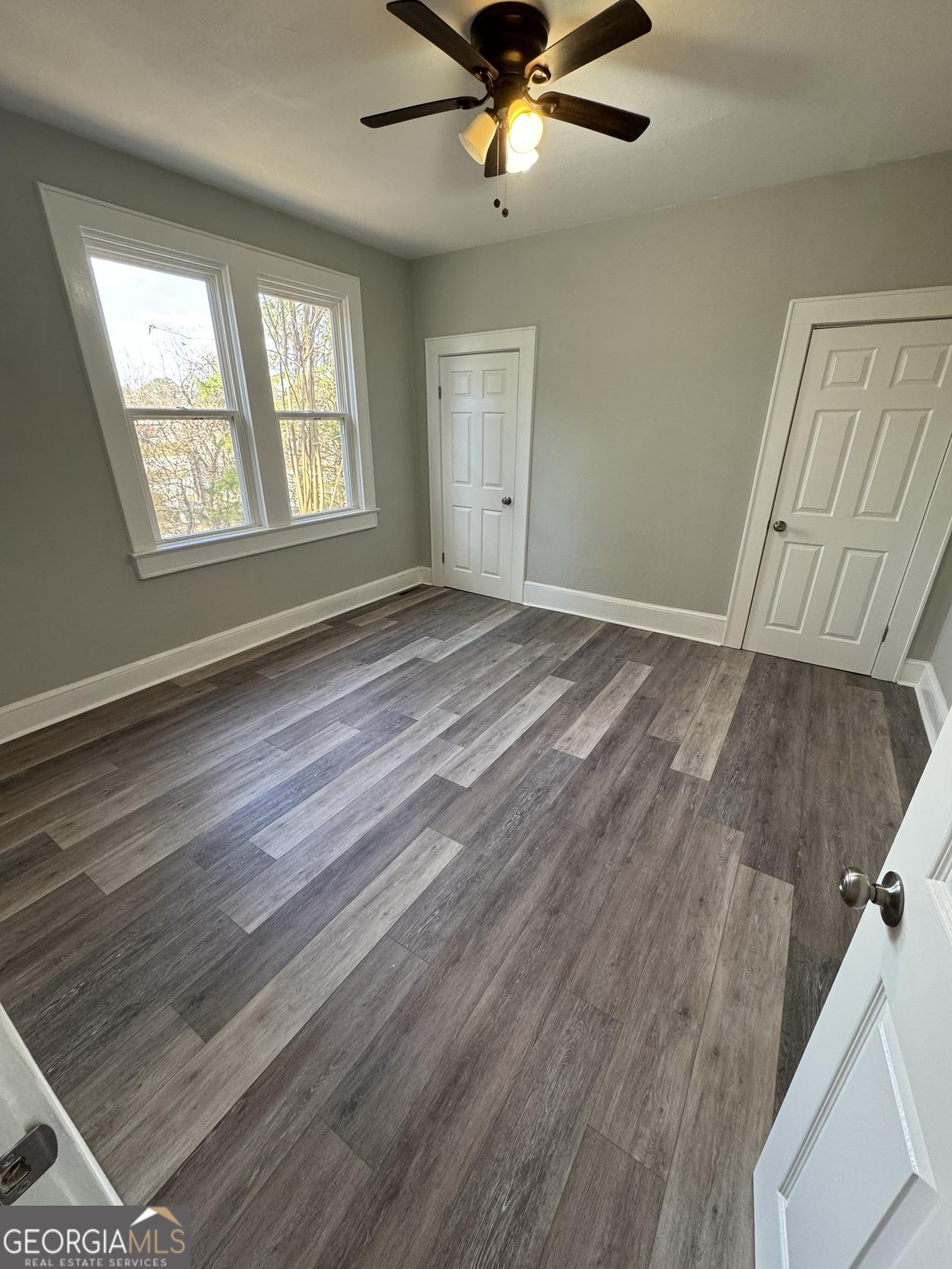 37 West Church Street Elberton, GA 30635 - Photo 18 of 37 a view of an empty room with wooden floor and a window