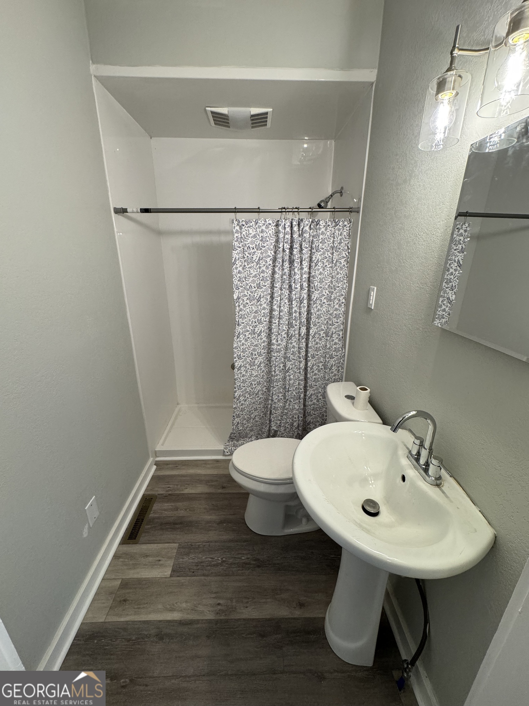 37 West Church Street Elberton, GA 30635 - Photo 19 of 37 a bathroom with a sink toilet and a mirror