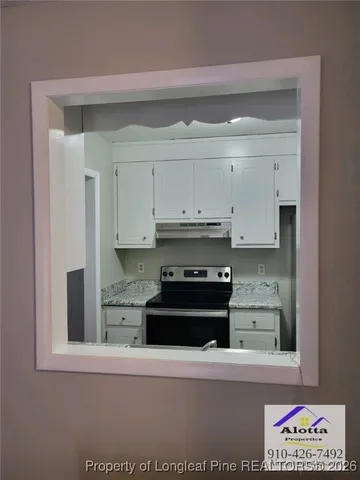 a kitchen with stainless steel appliances granite countertop a refrigerator and a stove