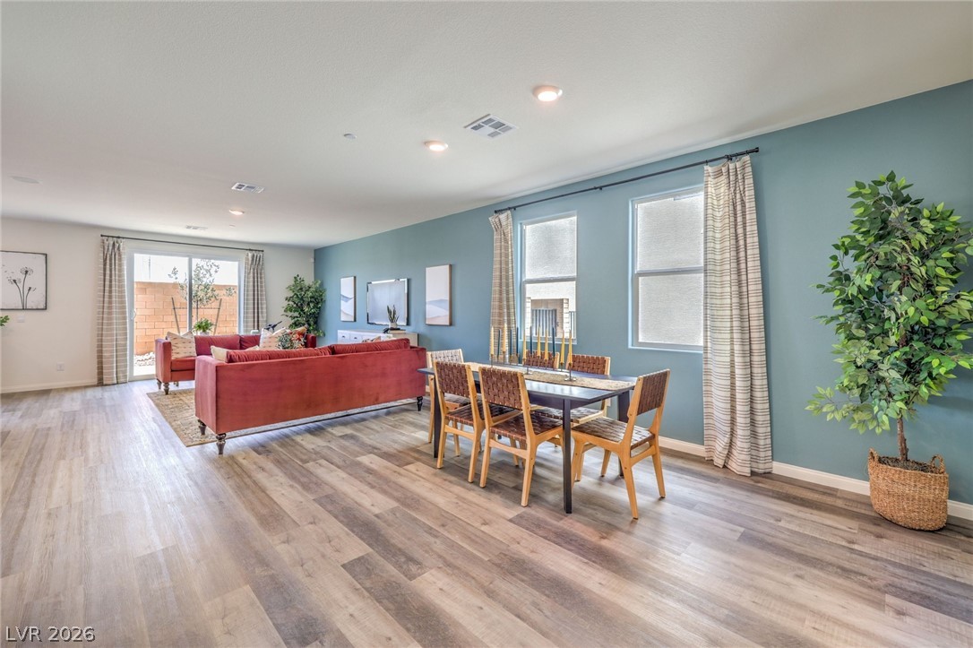 1017 Copper Robin Street Henderson, NV 89011 - Photo 8 of 43 Dining area with light wood-style flooring, baseboards, and recessed lighting