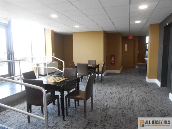 a room with pool table and windows