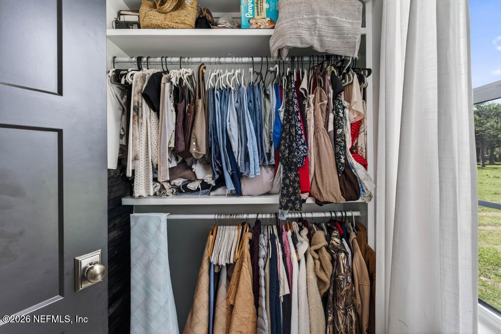 2955 Carroll Corner Road Hilliard, FL 32046 - Photo 65 of 106 a view of walk in closet with clothes