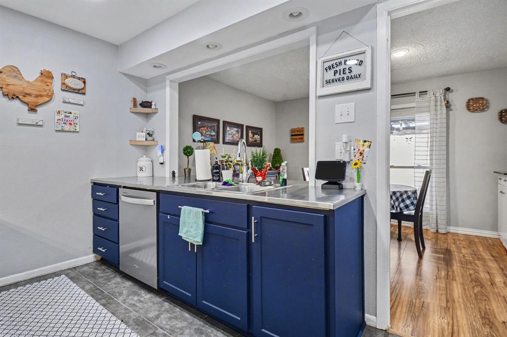 9446 Chimney Corner Dallas, TX 75243 - Photo 11 of 39 a kitchen with stainless steel appliances granite countertop a sink and a refrigerator