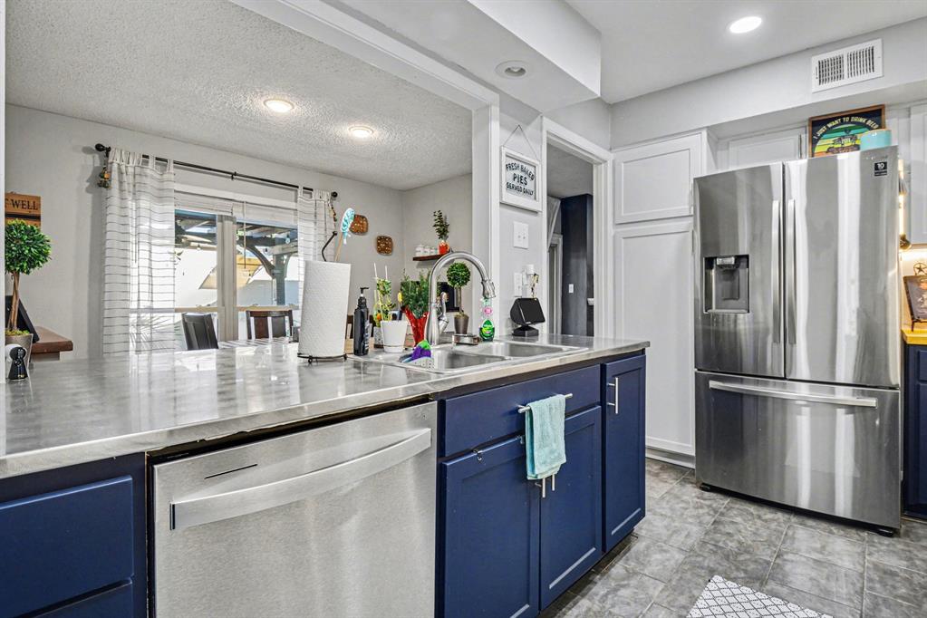 9446 Chimney Corner Dallas, TX 75243 - Photo 12 of 39 a kitchen with stainless steel appliances granite countertop a refrigerator and a sink