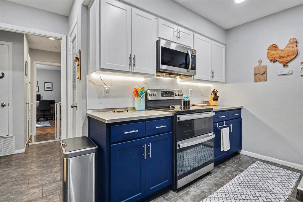 9446 Chimney Corner Dallas, TX 75243 - Photo 13 of 39 a kitchen with stainless steel appliances granite countertop a stove a sink and a refrigerator