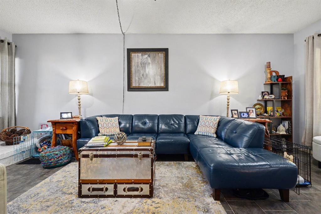 9446 Chimney Corner Dallas, TX 75243 - Photo 15 of 39 a living room with furniture a rug and a lamp
