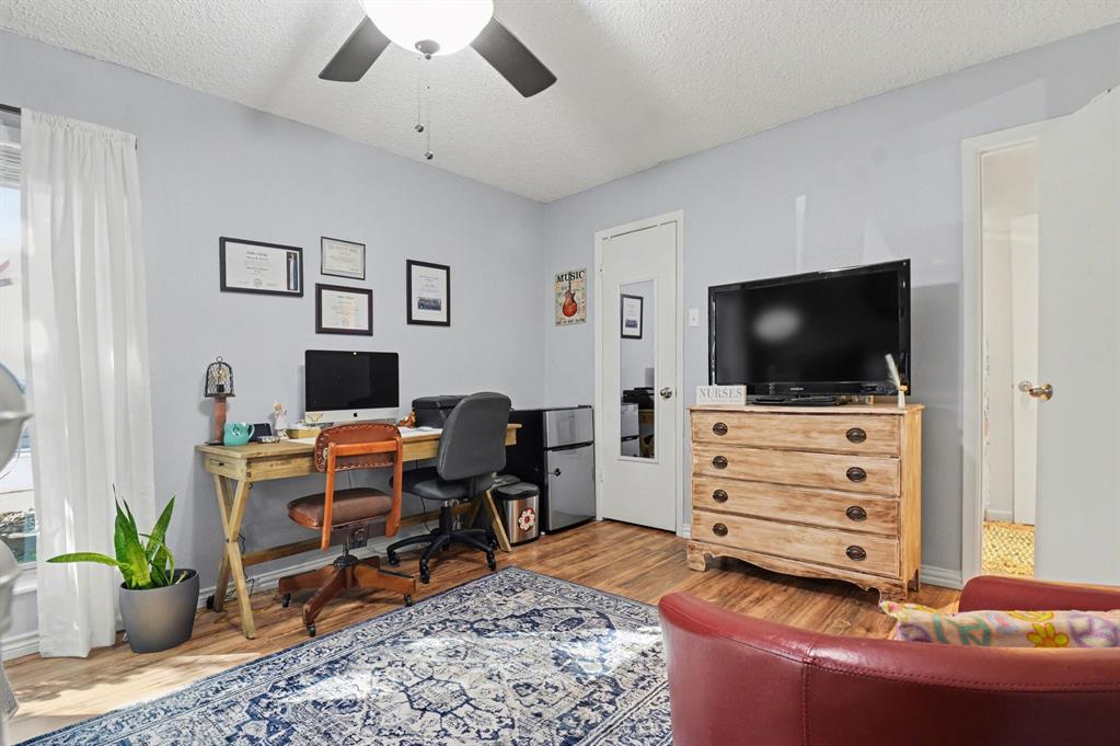 9446 Chimney Corner Dallas, TX 75243 - Photo 17 of 39 a living room with furniture and a flat screen tv