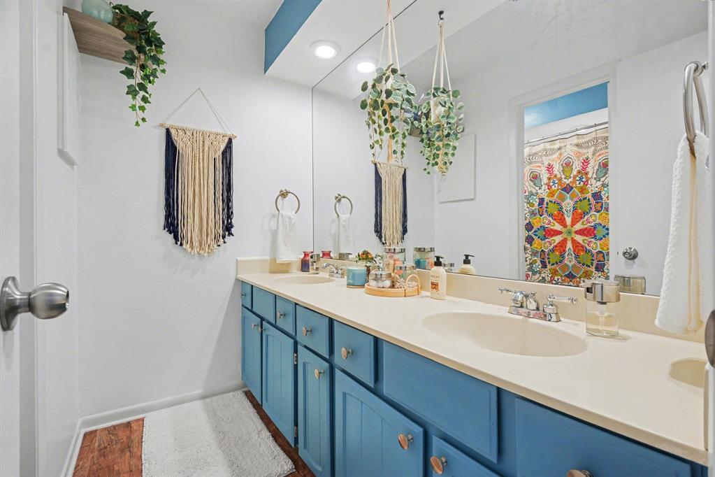 9446 Chimney Corner Dallas, TX 75243 - Photo 21 of 39 a bathroom with a sink a large mirror and a shower