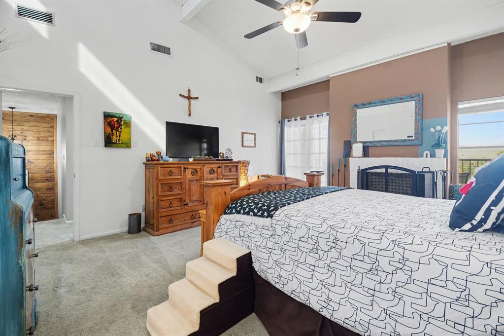 9446 Chimney Corner Dallas, TX 75243 - Photo 22 of 39 a bedroom with a bed and dresser with mirror