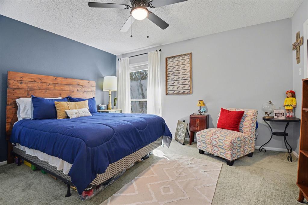 9446 Chimney Corner Dallas, TX 75243 - Photo 25 of 39 a bedroom with a bed and window