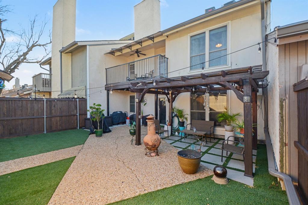 9446 Chimney Corner Dallas, TX 75243 - Photo 38 of 39 a view of a patio with a table and chairs under an umbrella