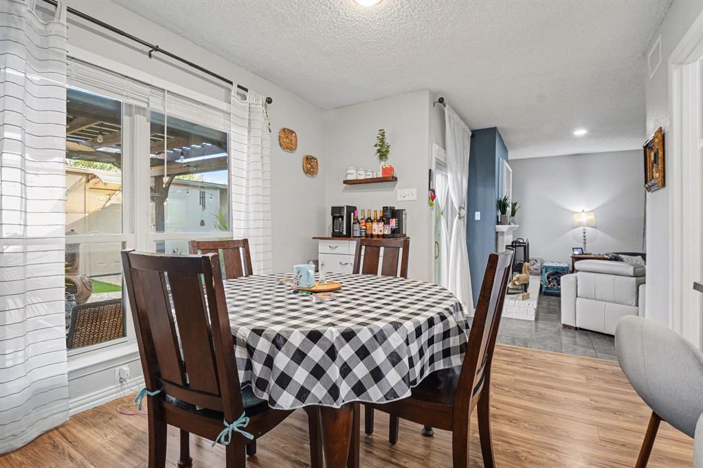 9446 Chimney Corner Dallas, TX 75243 - Photo 8 of 39 a view of a dining room with furniture window and wooden floor