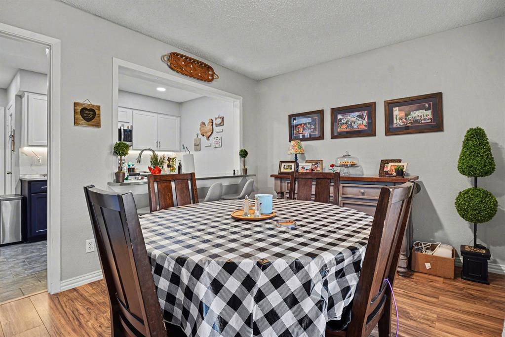9446 Chimney Corner Dallas, TX 75243 - Photo 9 of 39 a view of a dining room with furniture and wooden floor