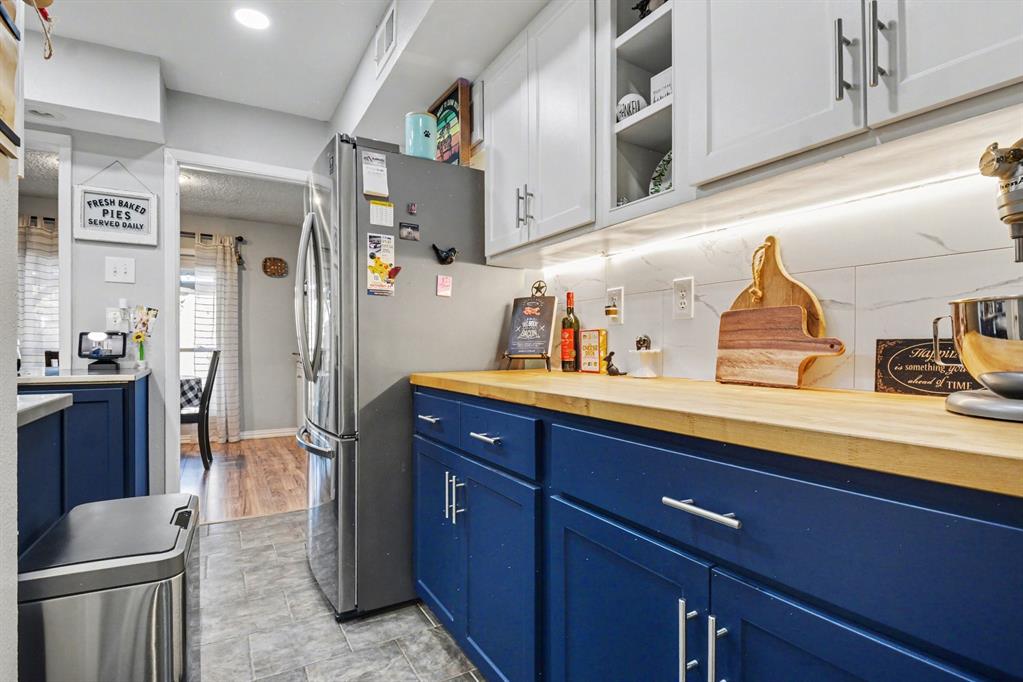 9446 Chimney Corner Dallas, TX 75243 - Photo 10 of 39 a kitchen with a sink and a refrigerator