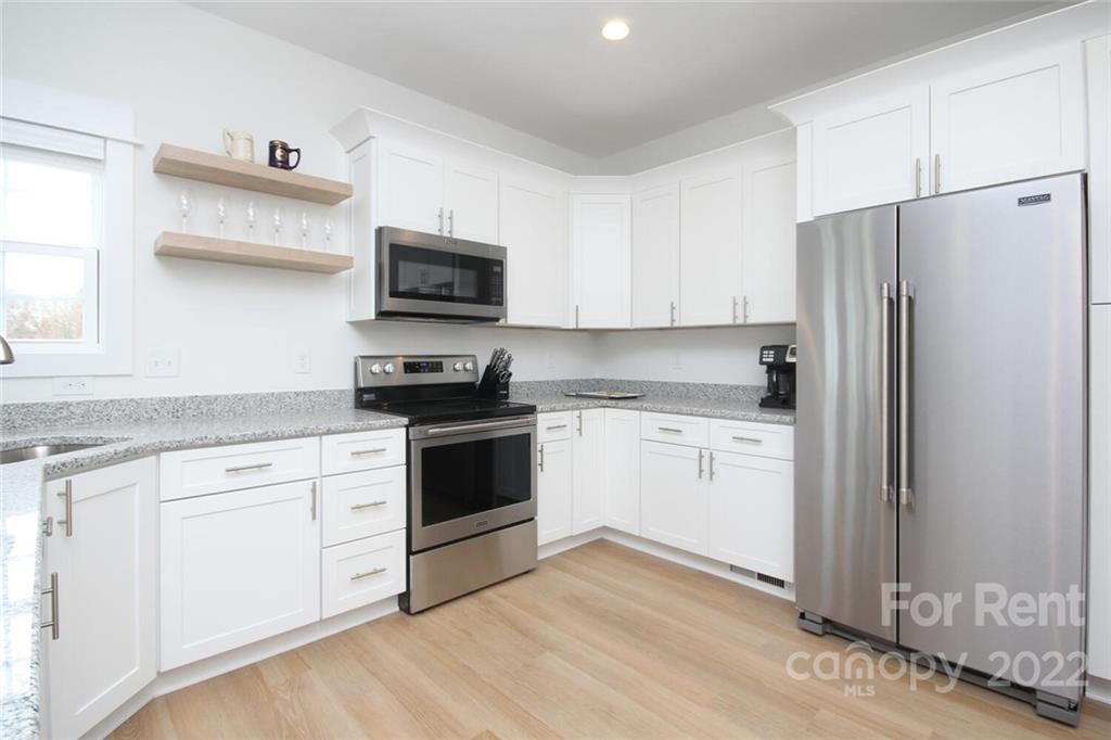 1100 Startown Road Lincolnton, NC 28092 - Photo 15 of 48 a kitchen with granite countertop white cabinets and stainless steel appliances