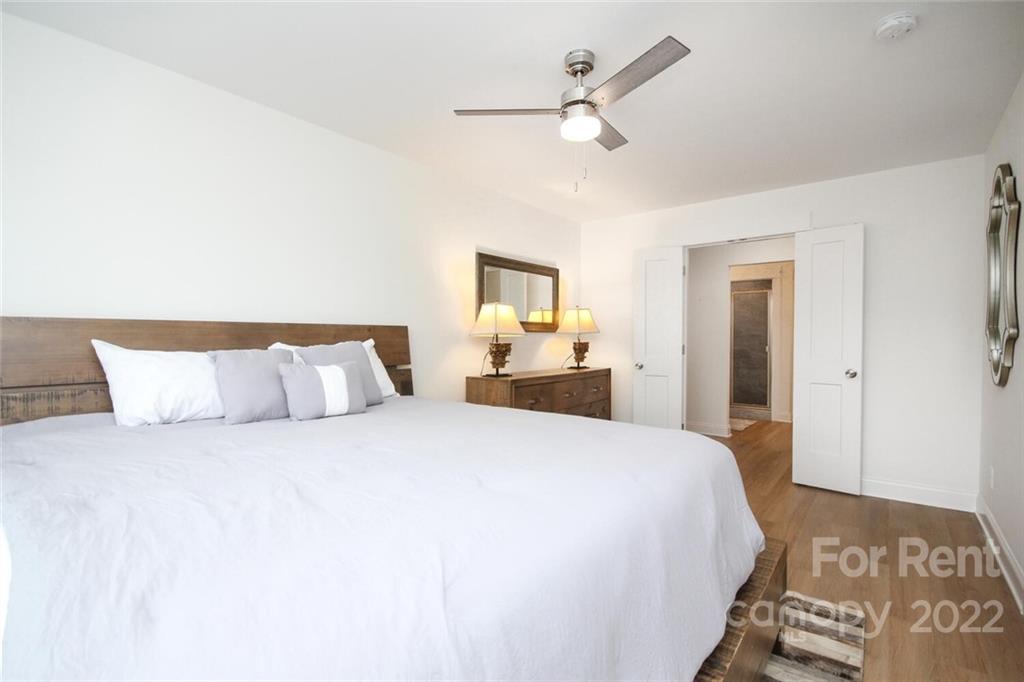 1100 Startown Road Lincolnton, NC 28092 - Photo 28 of 48 a bedroom with a large bed and a chandelier