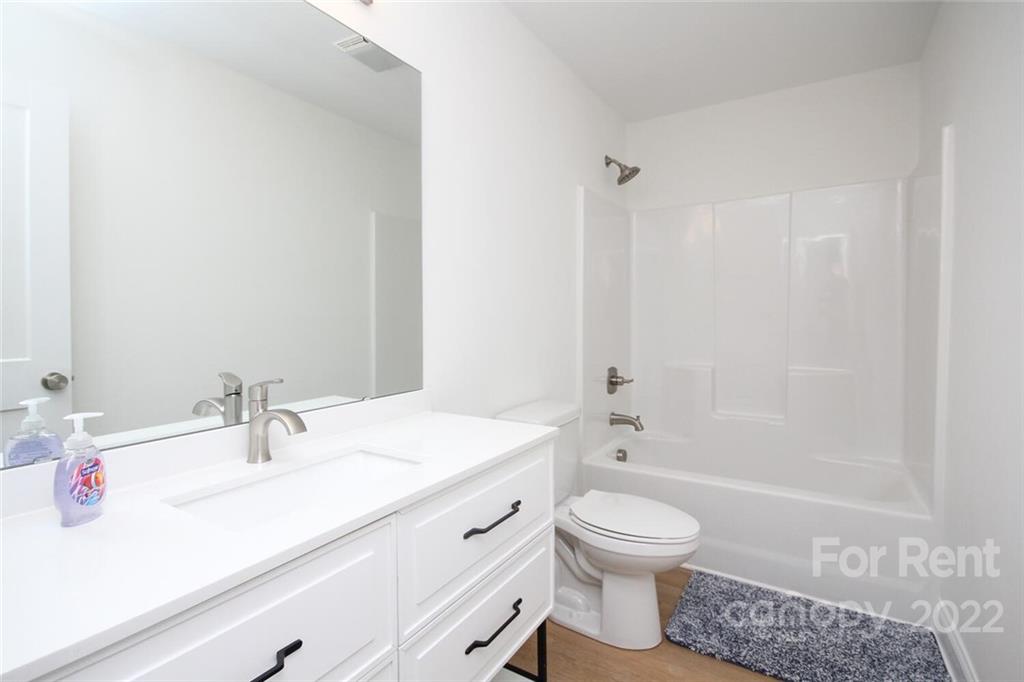 1100 Startown Road Lincolnton, NC 28092 - Photo 39 of 48 a bathroom with a granite countertop sink a toilet and a large mirror