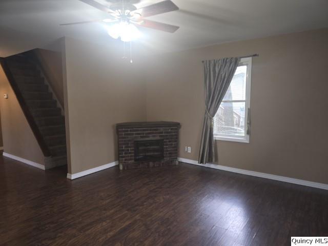 303 North Washington Street Carthage, IL 62321 - Photo 9 of 25 an empty room with wooden floor and windows