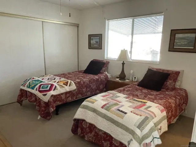 a bedroom with two beds and a window