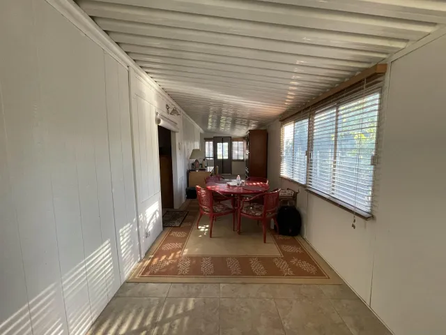a dining room with furniture and a window