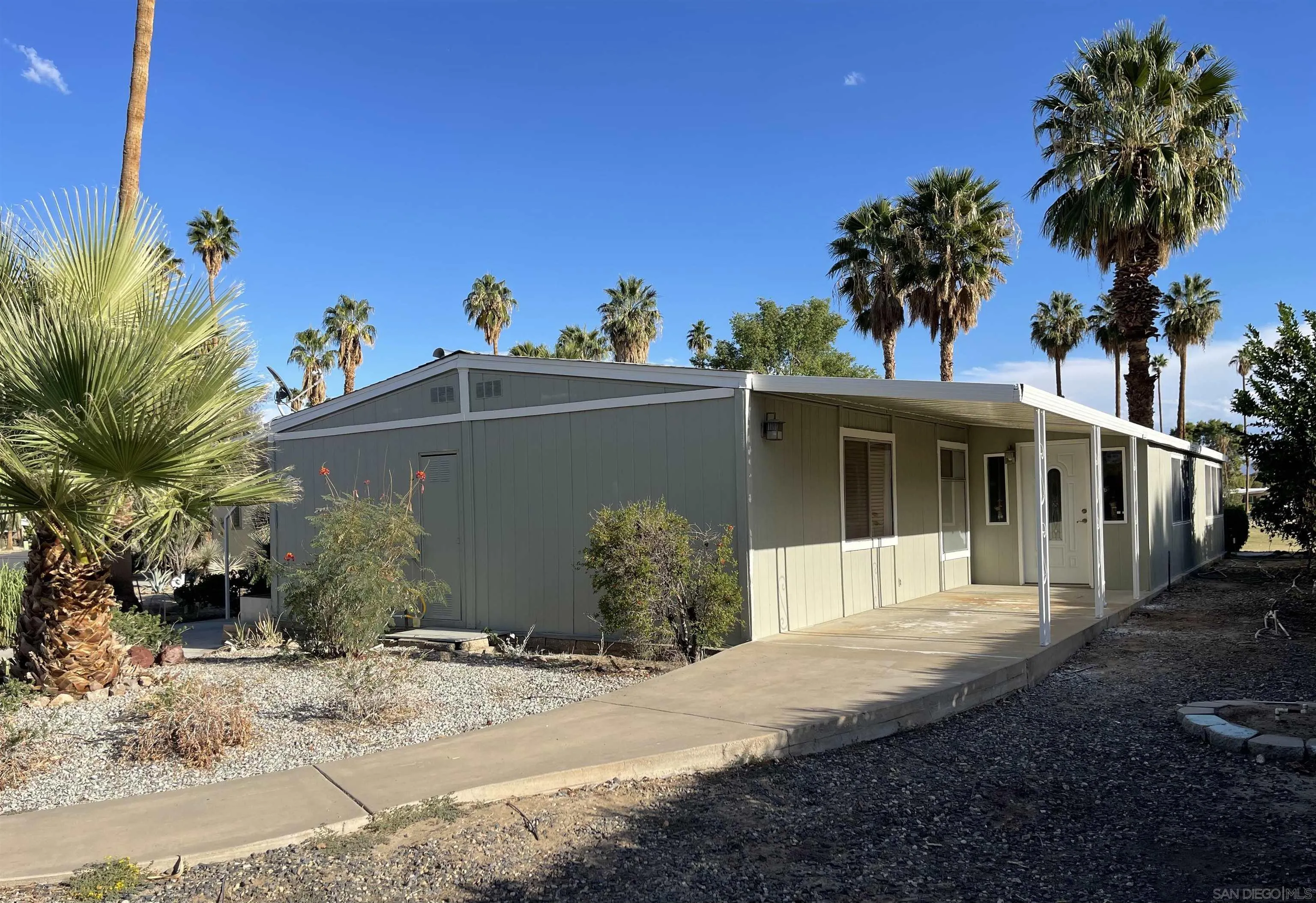 1010 Palm Canyon Drive, Unit 167 Borrego Springs, CA 92004 - Photo 20 of 22 a front view of a house with a yard and garage