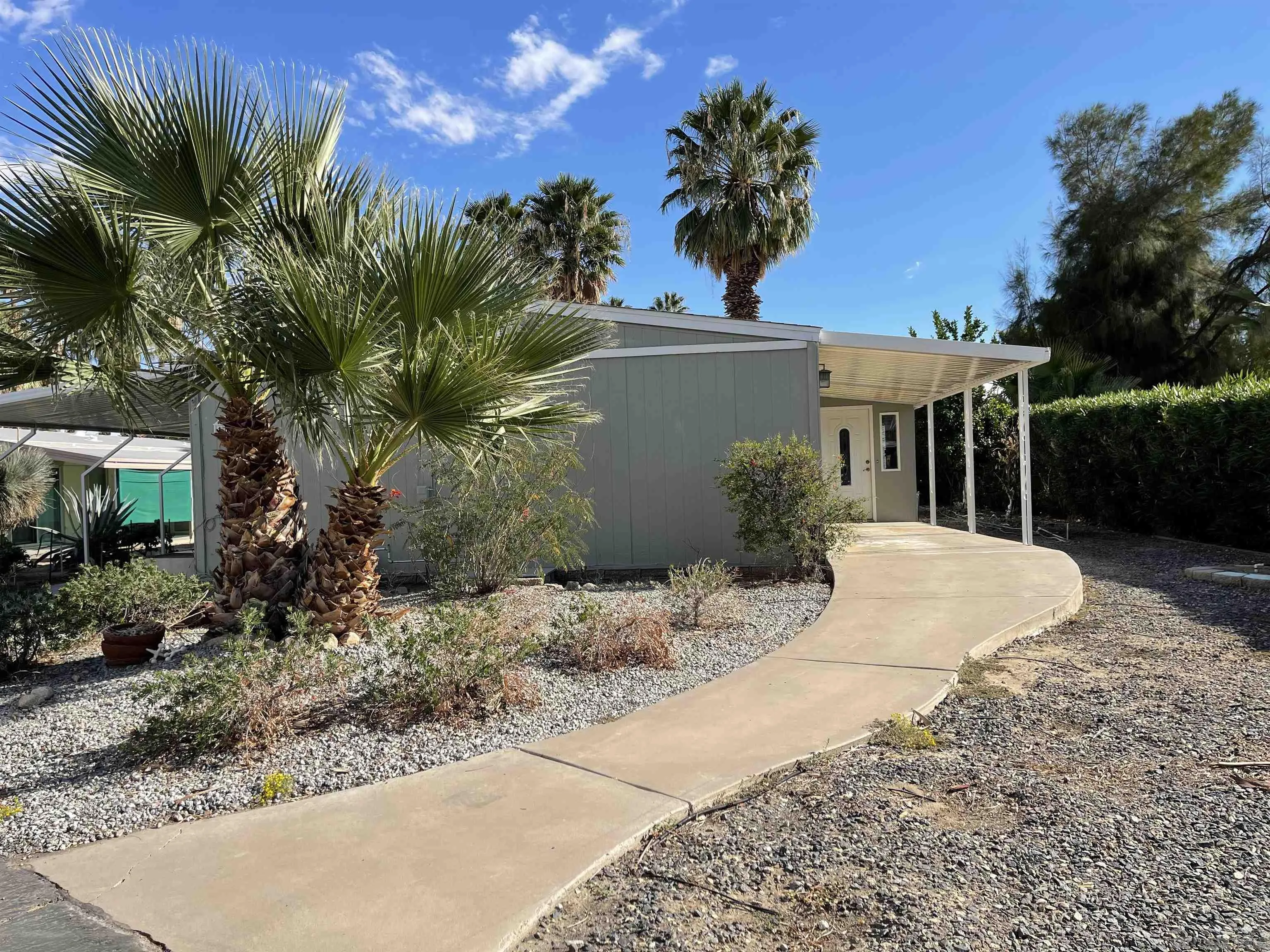 1010 Palm Canyon Drive, Unit 167 Borrego Springs, CA 92004 - Photo 5 of 22 a view of a house with a yard and potted plants