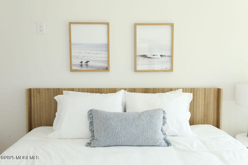 153 Atlantic Avenue Long Branch, NJ 07740 - Photo 18 of 46 a bedroom with a large bed and a couch