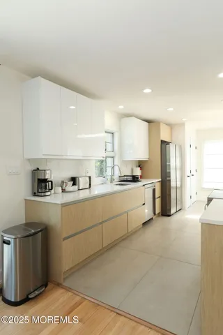 a large bed sitting in a bedroom next to a window