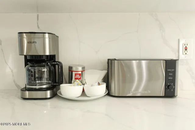 a view of a patio with table and chairs with wooden floor and fence